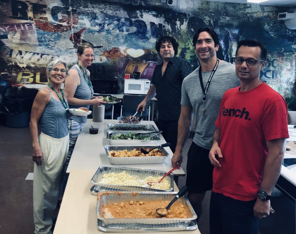 Staff serving food in rec room